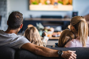 Family enjoying a movie after receiving ecomaids apartment cleaning services in Sugar Land.